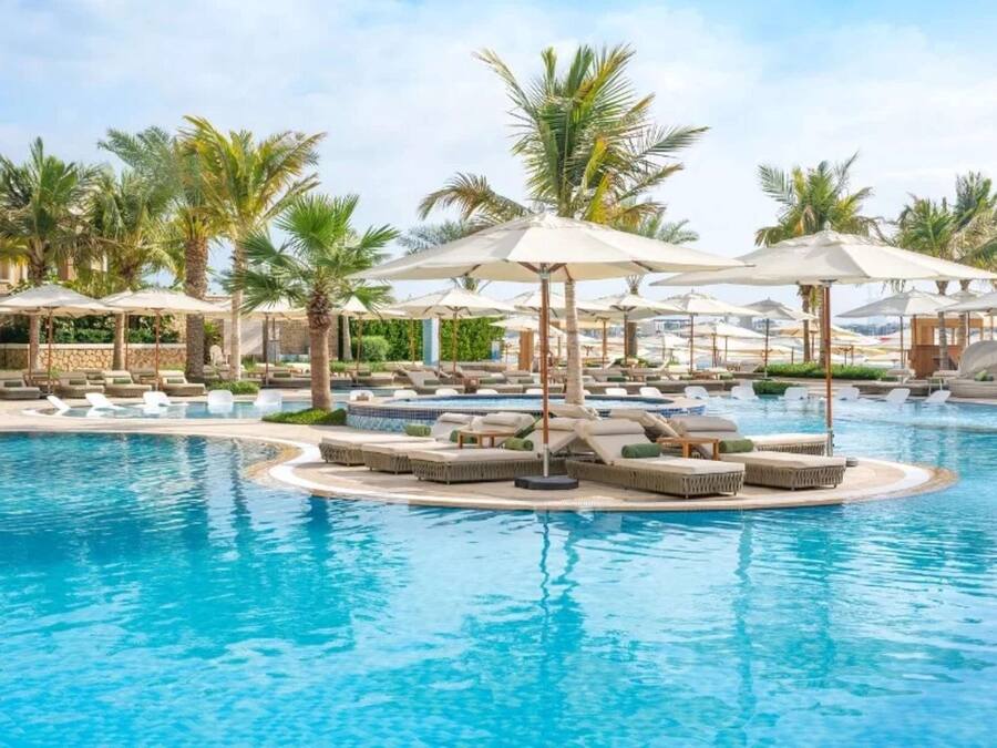 Outdoor pool, open 7:00 AM to 9:00 PM, pool loungers