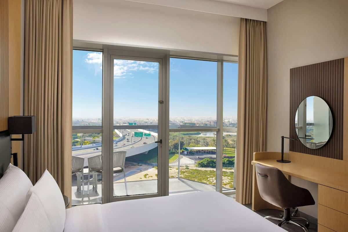 Deluxe Room, 1 King Bed, Balcony, City View | Down duvets, in-room safe, desk, blackout curtains