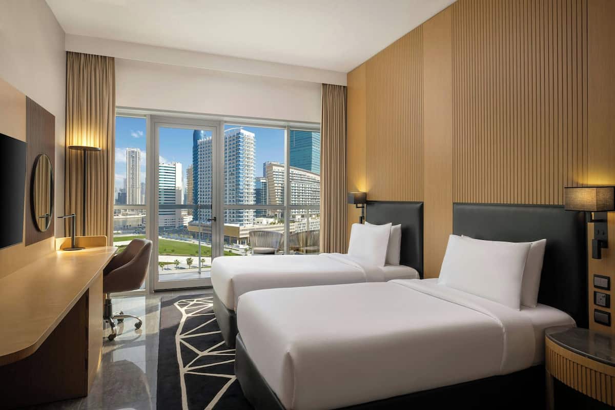 Deluxe Room, 2 Single Beds, Balcony, City View | Down duvets, in-room safe, desk, blackout curtains