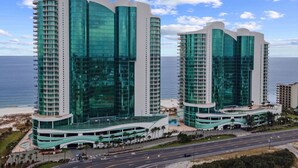 Two high-rise buildings with a curved design, featuring large glass windows and a white facade. - Turquoise Place!  New Rental!! (Orange Beach)