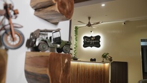 A reception desk with a sign reading "Casa Franquejoons Boutique Hotel," a ceiling fan, and a motorcycle. - Justa Casa Frangipani Assagao, Goa (Assagao)