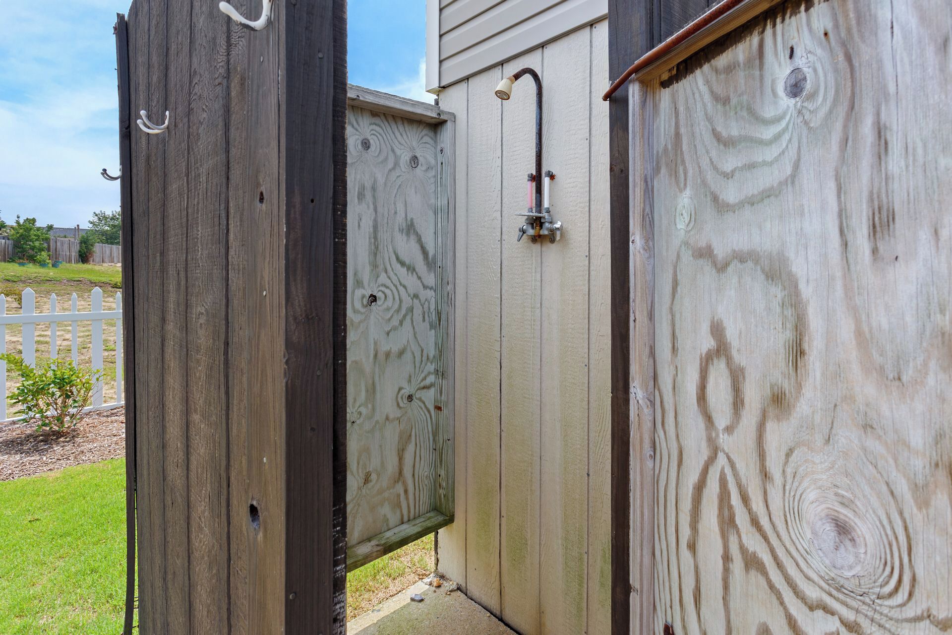 A wooden structure with a door and a window, possibly a shed or a small building.