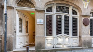 A building entrance with a sign for 'Galerias Fashion Plots' and a plaque with text. - Galerias Cashmere Nightlife 302 by Feel Porto (Porto)