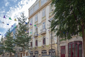 Ein mehrstöckiges Gebäude mit Balkonen, großen Fenstern und Blick auf die Straße.