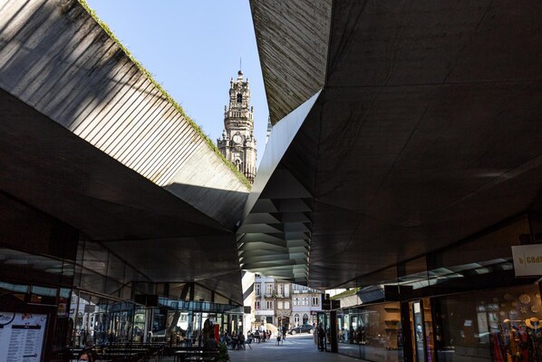 An urban plaza with a modern architectural design, featuring a prominent clock tower in the background. - Galerias Iconic Nightlife 204 by Feel Porto (Porto)
