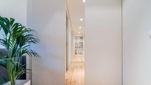 A hallway with a wooden floor and a motivational quote on the wall. - Feel Porto Downtown City Break (Porto)
