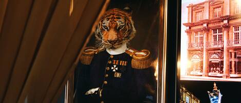 A framed tiger portrait with medals, a building with 'TERRY' on it, and a street lamp.