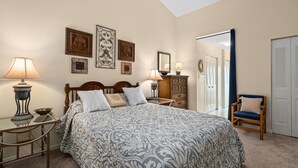 A bedroom with a bed, bedside tables, a dresser, a chair, and a wardrobe. - 1 BR 1.5 Canal Front Unit with Pool! (Ocean City)