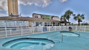 A swimming pool area with a sign for Bikini Bob's Bar & Grill. - Summit 1218, 1 Bedroom, Beachfront Slps 5 w/Beach Chairs! (Panama City Beach)