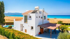 A modern white villa with a pool, a covered patio, and a view of the sea. - Blue Bay Villa Thea - Three Bedroom Villa, Sleeps 6 (Polis)