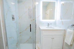 Shower, hair dryer, towels, soap
