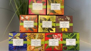 A display of The Secret Garden organic tea boxes in various flavors, arranged on a shelf. - Explore Downtown and Mount Adams with River Views! (Cincinnati)