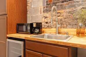 Fridge, microwave, coffee/tea maker, cookware/dishes/utensils
