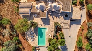 An aerial view of a property with a swimming pool, outdoor seating area, and multiple large cylindrical structures. - Trullo La Succulenta - Le Case di Valentina (Ceglie Messapica)