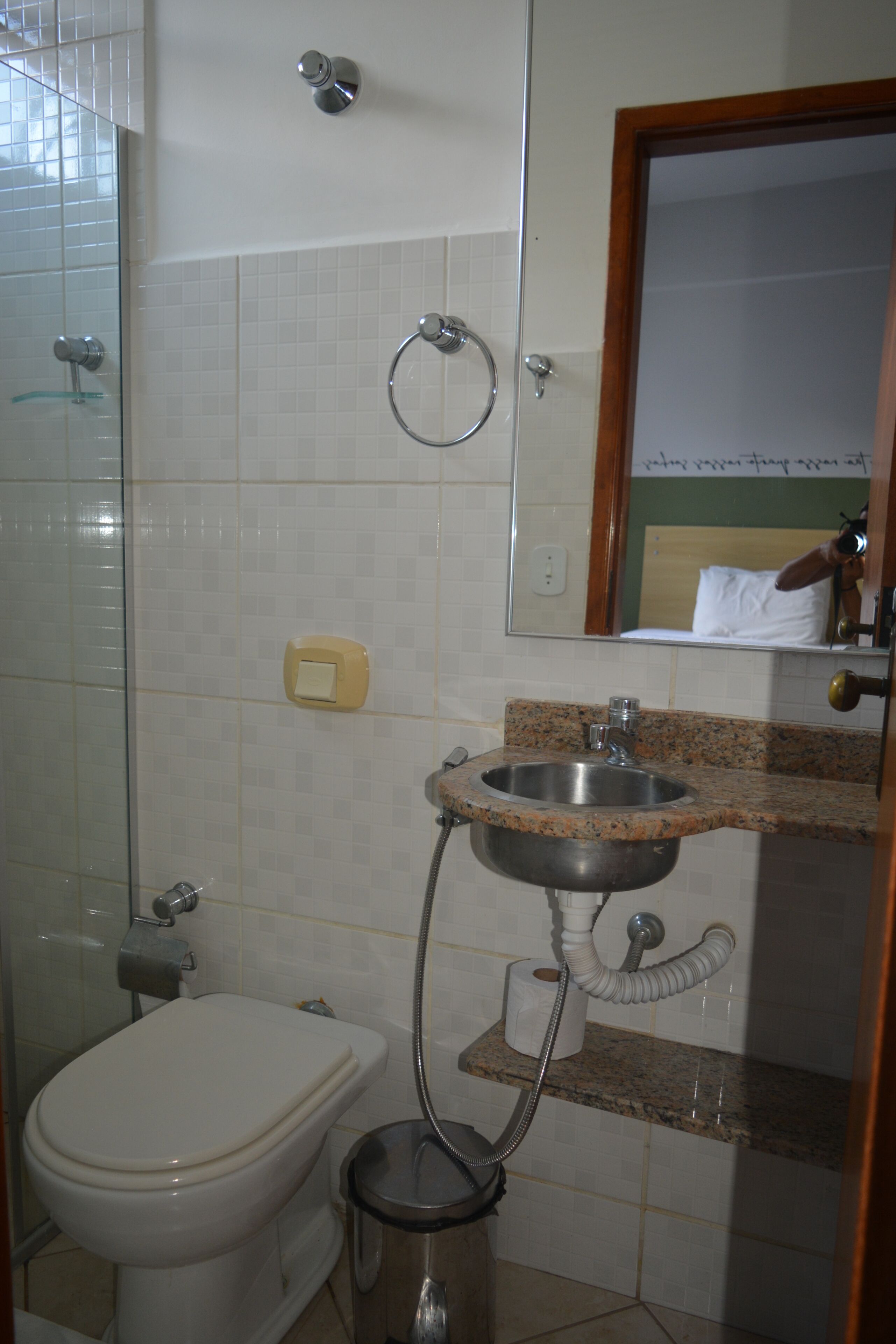 A bathroom with a toilet, sink, and shower.
