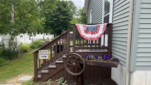 A wooden staircase with a sign indicating the Airbnb entrance.