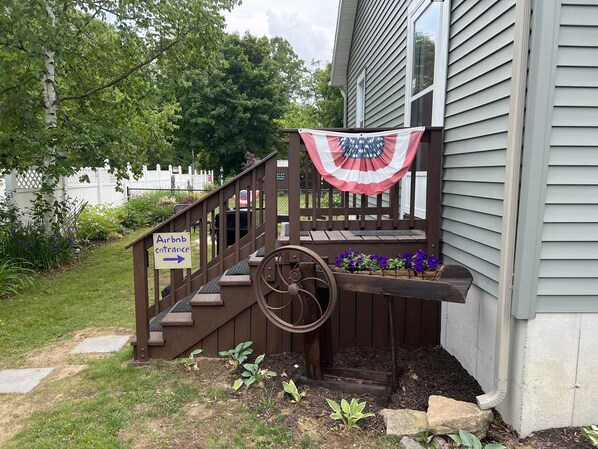 A wooden staircase with a sign indicating the Airbnb entrance. - Experience the Adirondacks (Mayfield)