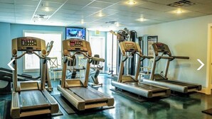 A gym with treadmills and elliptical machines.