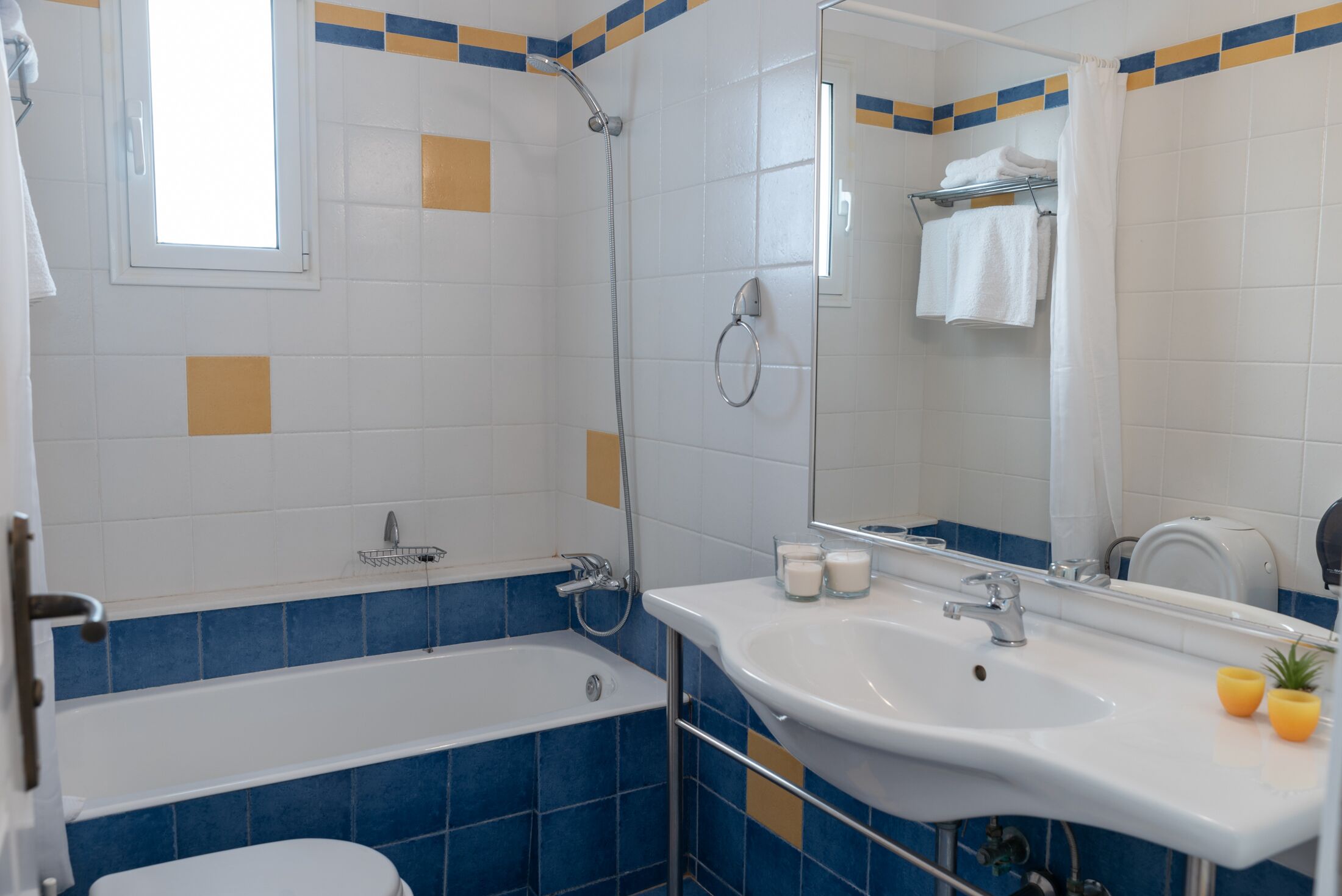 A bathroom with a bathtub, a sink, a mirror, and a shower.