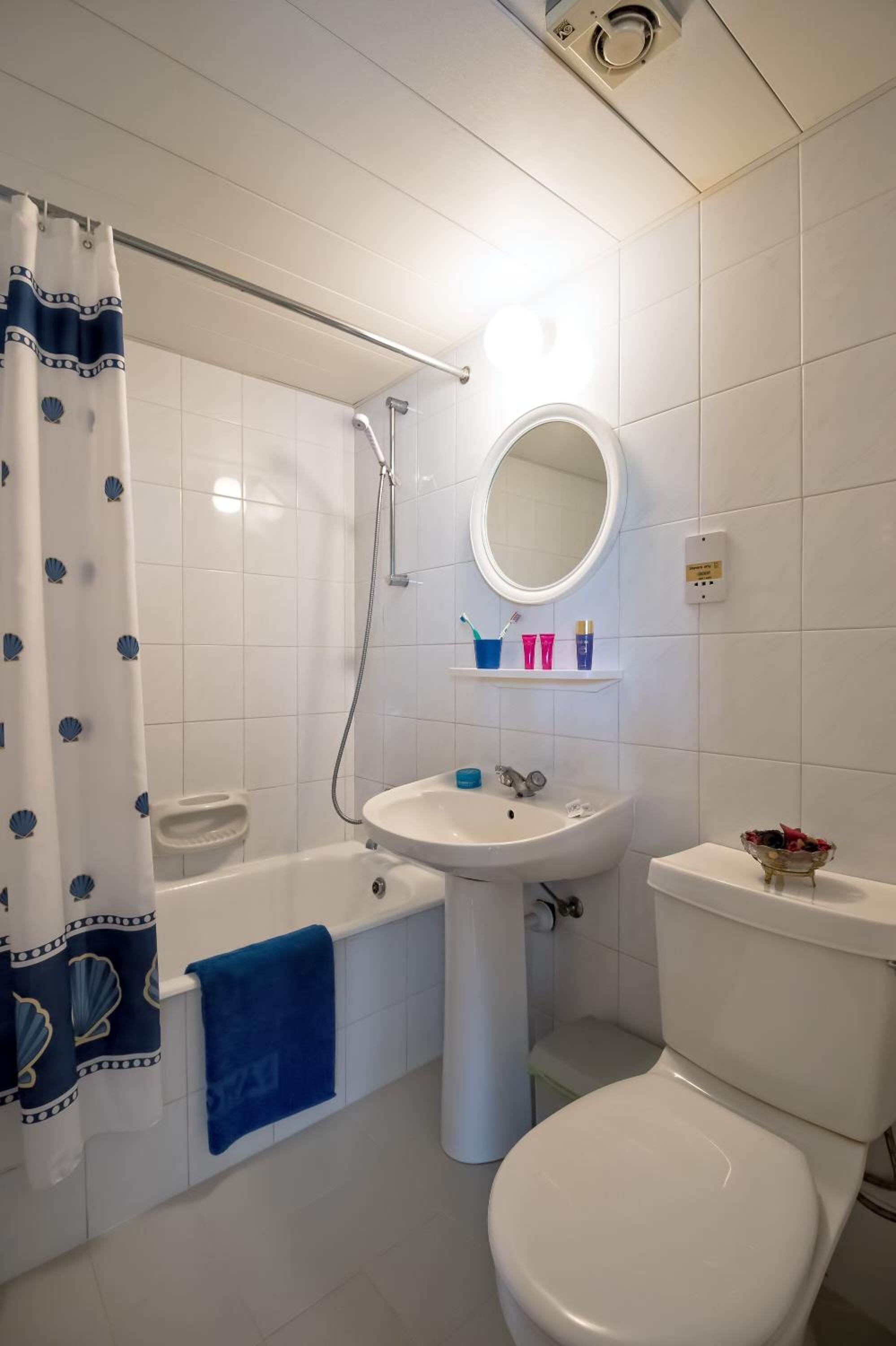 A bathroom with a bathtub, sink, toilet, and a shower.