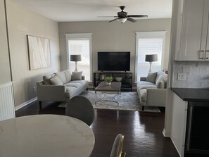 Relax in this stylish living room with a sofa set, coffee table, and flat-screen TV.