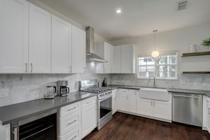 Enjoy cooking in this well-equipped kitchen with an oven, dishwasher, and stainless steel range hood.
