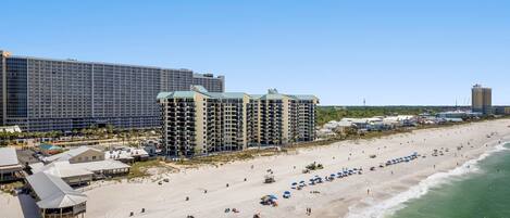 A beachfront hotel with multiple buildings, a sandy beach, and ocean views.