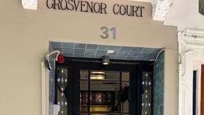 A building entrance with a sign reading "Grosvenor Court 31". - ART DECO BAYSIDE APARTMENT CLOSE TO THE CITY (Elizabeth Bay)