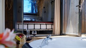 A bathroom with a bathtub, a sink, and a window. - Mossa Afkule (Fethiye)