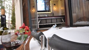 A dining table with a wine bottle, a glass of red wine, and a glass with strawberries. - Mossa Afkule (Fethiye)