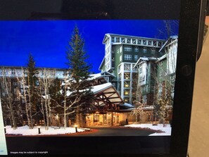 Hotel features a striking glass facade and distinctive roof structure.