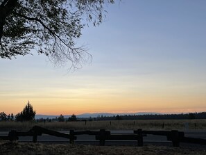 A sunset view with a road and a wooden fence. - Millz Manor at Fall River Millz (Fall River Mills)