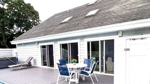 A house with a swimming pool, a patio with a table and chairs, and a covered area with a sliding door. - Pristine Remsenburg Retreat to Play & Work All Summer Long (Remsenburg)
