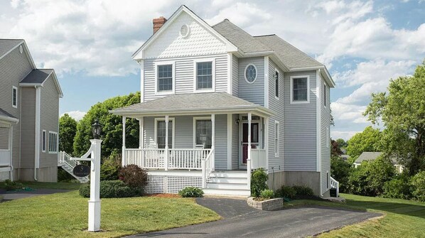 A two-story house with a front porch, a chimney, and a mailbox. - Beautiful Beach Home Only Seconds from the Sand! (York)