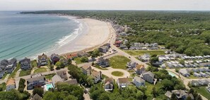 An aerial view of a coastal residential area with houses, a beach, and a small pool. - Beautiful Beach Home Only Seconds from the Sand! (York)