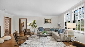 A living room with a sofa, chairs, a coffee table, and a large window. - Spacious 3b/3b Mediterranean in White Plains (White Plains)