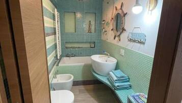 Bathtub, hair dryer, bidet, towels