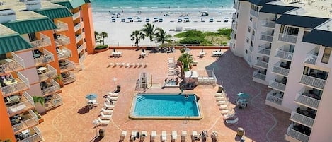 A resort with a pool, beach, and ocean view.