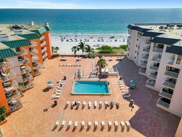 A resort with a pool, beach, and ocean view.