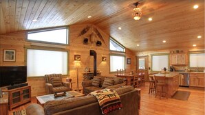 A spacious cabin with a living area, dining space, and kitchen.