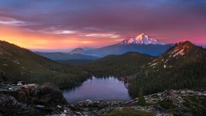 A mountain landscape with a lake and a snow-capped peak.