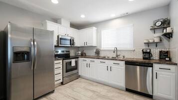 Enjoy cooking in this well-equipped kitchen with a refrigerator, microwave, oven, and dishwasher.