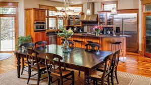 A spacious kitchen with wooden cabinets, stainless steel appliances, and a central island with seating.