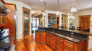 A spacious kitchen with wooden cabinets, granite countertops, and stainless steel appliances.