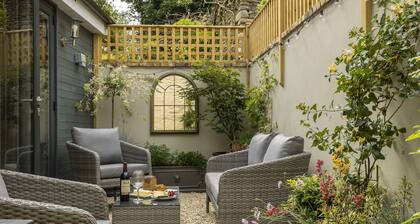 This charming Cotswold stone cottage, elegantly furnished with a seamless blend of antique and conte