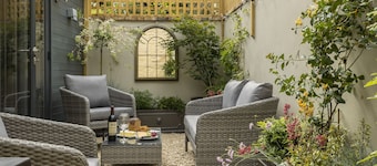 This charming Cotswold stone cottage, elegantly furnished with a seamless blend of antique and conte