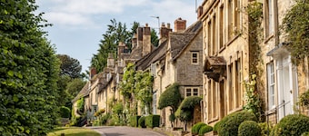 This charming Cotswold stone cottage, elegantly furnished with a seamless blend of antique and conte