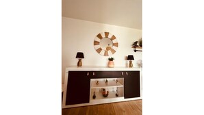 A white console table with a round mirror, two black lamps, and decorative items including a pineapple and a plant. - LE TERRACOTTA T4 SLEEPS 6, AIR-CONDITIONED, WITH PARKING SPACE (Caluire-et-Cuire)