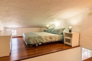 A bedroom with a bed, bedside tables, a desk, and a window. - Holiday Home Ca Martina Sonora Golf with Pool, Garden and Wi-Fi (Maspalomas)