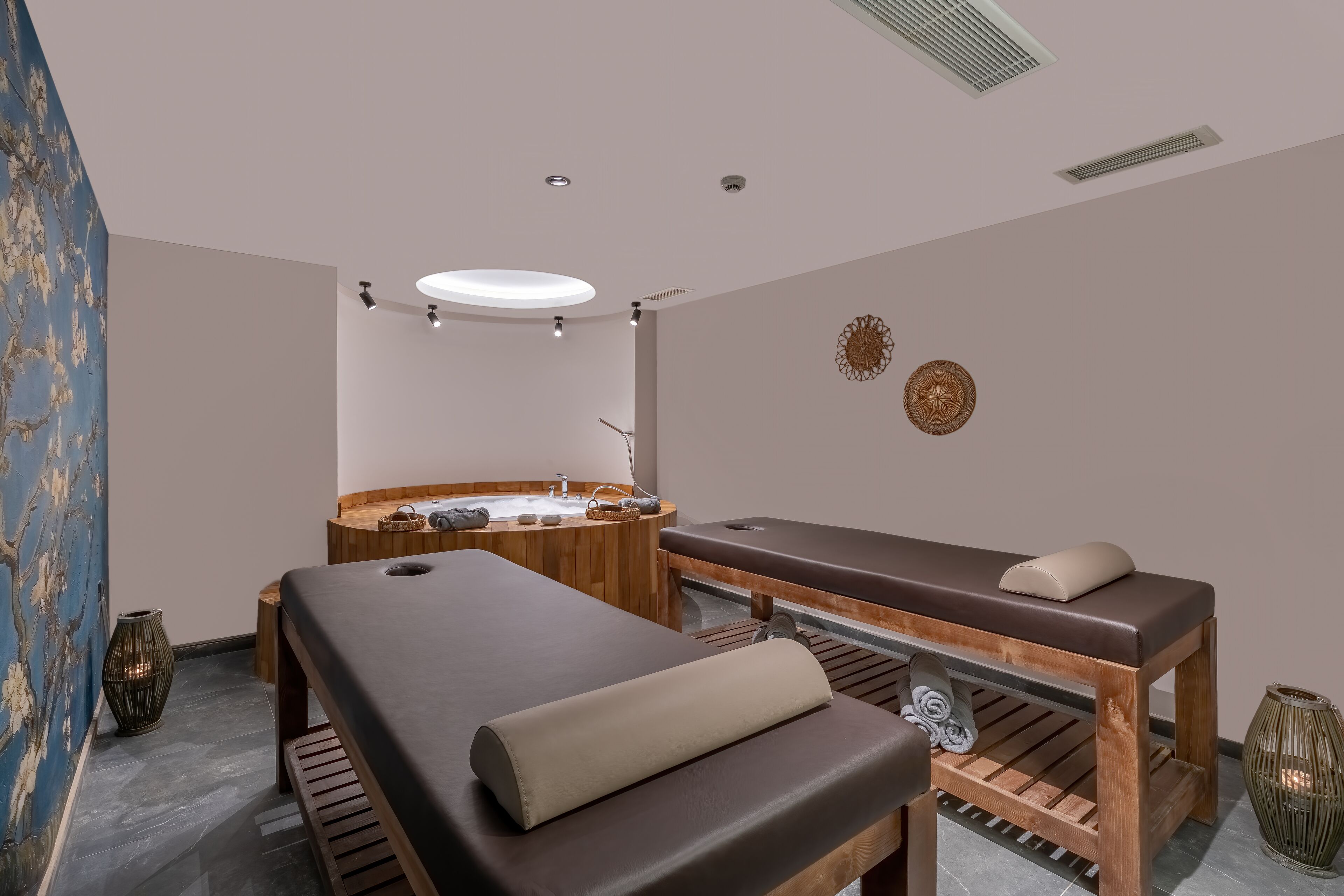 Un cuarto de spa con una camilla de masaje, un banco de madera y una bañera de madera.